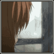 a close up of a person 's hair looking out of a window .