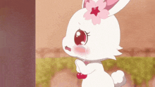 a white rabbit with a pink flower on her head is crying