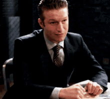 a man in a suit and tie is laughing with the caption carisbot