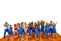 a group of children in blue dresses and striped socks are dancing