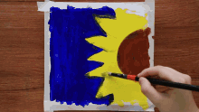 a person is painting a picture of a crown with a brush