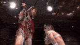 two women wrestling in a ring with the word stardom on the bottom right