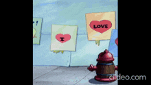 a fire hydrant is standing in front of a wall with signs that say love and i love you