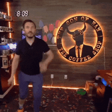 a man is dancing in front of the son of han coffee shop logo
