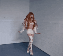 a woman with red hair is wearing a white jacket and a white skirt