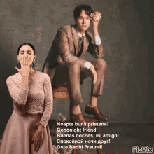 a man in a suit sits next to a woman in a pink dress