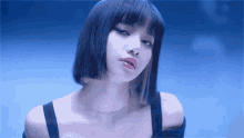 a close up of a woman 's face with a blue background .