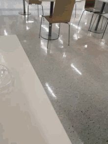 a blurred image of a person using a blender on a white surface