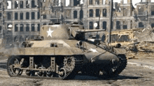 a tank with a star on the side is driving through a ruined city .