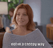 a woman sitting on a couch with the words not in a creepy way written below her