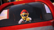 a lego character is sitting in the driver 's seat of a red car