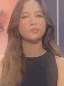 a close up of a woman making a funny face .