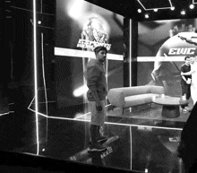 a man stands in front of a screen that says ewc