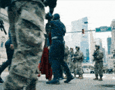 a group of soldiers are walking down a street with a sign that says waid on it
