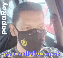 a man in a car wearing a mask that says " paparoy " on it
