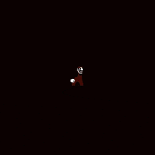 a skeleton is standing in the dark with a skull on his head .