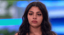 a close up of a woman 's face with a tear running down her cheek .
