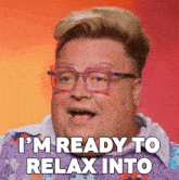 a man wearing glasses and a purple shirt says i 'm ready to relax into