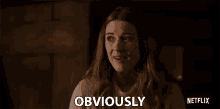 a woman with red hair is smiling and says obviously