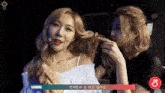two women are standing next to each other and one of them has a sign that says handong
