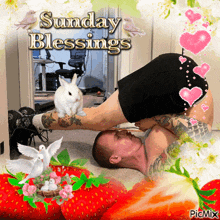 a man is laying on the floor with a rabbit on his leg and the words sunday blessings