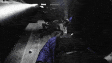 a person in a blue jacket laying on the floor