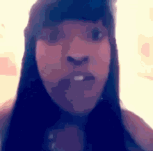 a close up of a woman 's face with long black hair