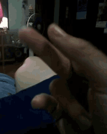 a close up of a person 's hand with their thumb up