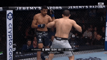 two men are fighting in a cage with jeremy 's razors on the fence