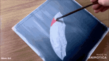 a person is painting a feather on a piece of paper that says wow art on the bottom