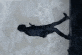 a silhouette of a person falling from a cliff
