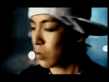 a close up of a person wearing a hat and bandana