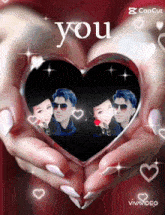 a couple of hands holding a heart that says you on it