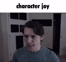 a man in a blue shirt is making a funny face with the words character joy above him .