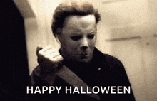 a black and white photo of a man with a mask and the words `` happy halloween '' written below him .