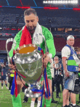 a man holding a trophy with the number 3 on it