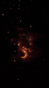 a close up of a yellow and red explosion with a black background