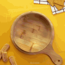 a wooden cutting board with the word mr.cakes written on it