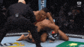 a referee in a boxing ring with ufc on the bottom right