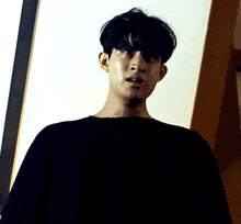 a man wearing a black shirt is crying