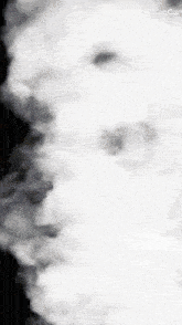 a black and white photo of smoke coming out of a chimney .