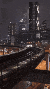a train going through a city at night with the word siemens in the background