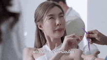 a woman is drinking from a plastic cup with a straw in her mouth .