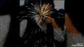 a video showing a man blowing out a firework display with the words happy birthday