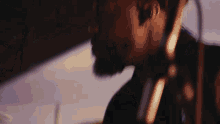 a close up of a man 's face with a microphone in his ear