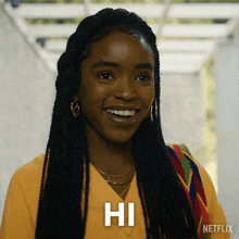 a woman in a yellow shirt is smiling and says hi on the bottom