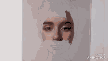 a person is painting a woman 's face with a brush on a piece of paper .