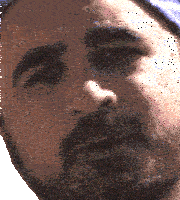a close up of a man 's face with a hat on