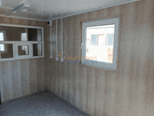 a room with wood paneling and a window with a sign that says " вытяжки " in the corner