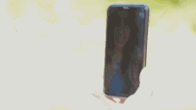 a man is taking a picture of a woman on a cell phone .